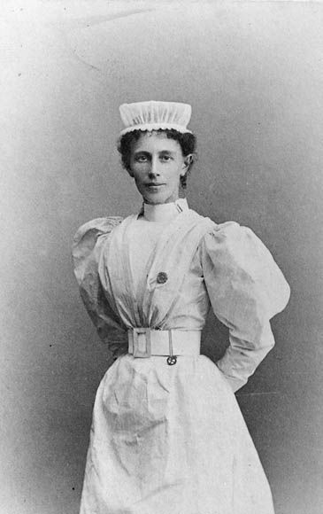 Black and white portrait of Georgina Pope in a nurse's uniform and cap